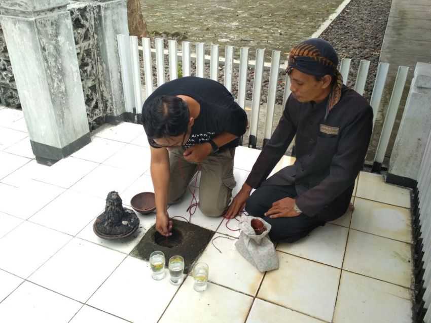 Seorang pengunjung mencoba menimba air dari Sumur Mas yang berada di komplek Kadipaten Banyumas atau komplek Kota Lama Banyumas.