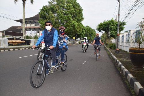 BONCENGAN : Bupati Achmad Husein bersama istrinya, Erna Husein berangkat ke kantor naik sepeda breboncengan (berduaan), Jumat (19/6) saat melintas di Jl Gatot Subroto Purwokerto. (SB/dok)